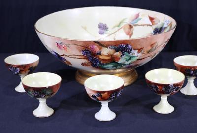 手绘利摩日瓷潘趣酒碗，有五个杯子、葡萄和鲜花，上面有奥地利的签名(估价:600- 1000美元)。